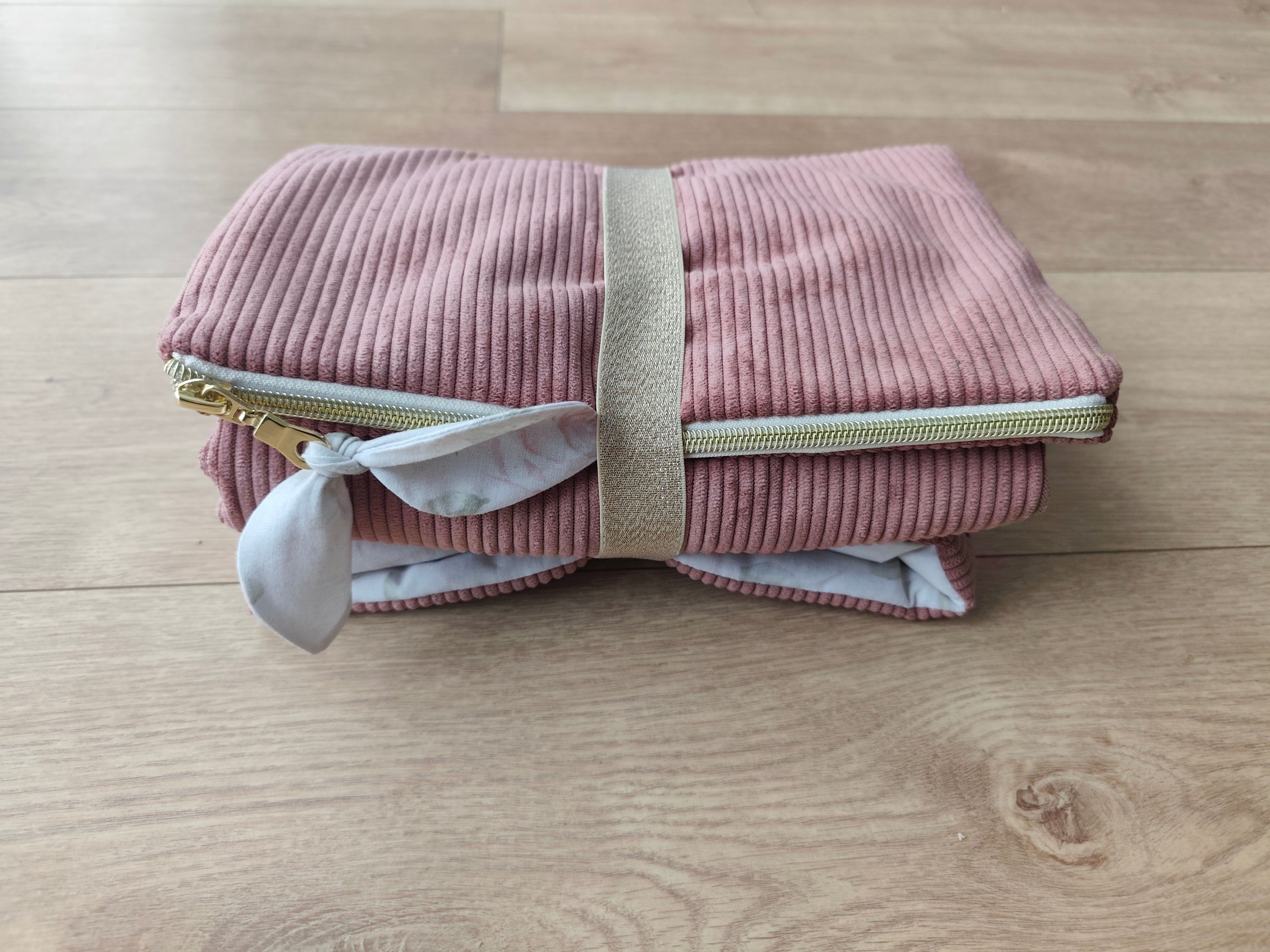 Tapis à langer nomade Léontine la Lapine plié en velours côtelé rose avec sangle dorée – Blanche & Noé